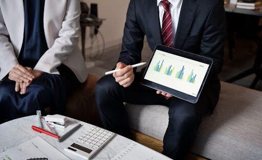Business people working with an iPad, high angle